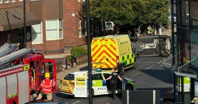 Road taped off after car 'overturns' with emergency services on scene