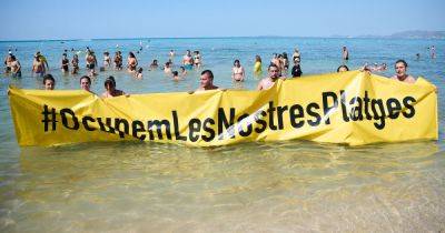 Anti-tourism protesters storm popular Majorca beach loved by UK tourists