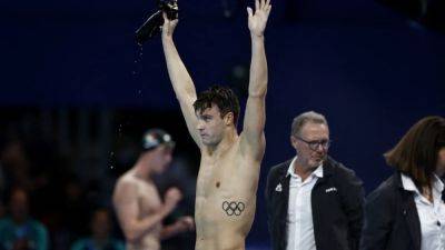 Finke breaks world record to win men's 1,500m freestyle gold