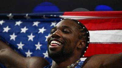 Lyles rides rollercoaster to 100m gold