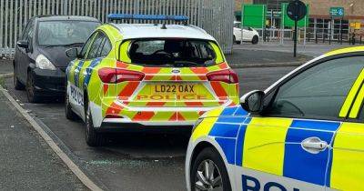 Police cars smashed in Morrisons car park during violent protests in Bolton
