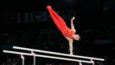 China's Zou Jingyuan repeats as Olympic parallel bars champion for 3rd medal in Paris