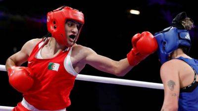 Boxers in gender dispute will remain in Paris Games competitions, IOC says