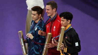 Denmark's Axelsen retains mens' Olympic badminton title