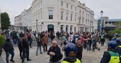 Beer and flares thrown in the air as two groups clash in protests in Plymouth