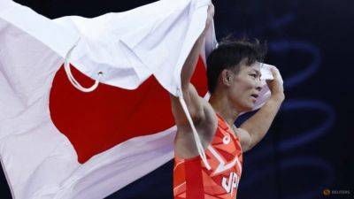 Wrestling-Japan's Higuchi wins men's 57kg freestyle gold