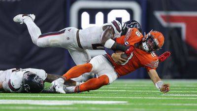 Bears' Roschon Johnson reacts after Texans' Azeez Al-Shaair punches him during game