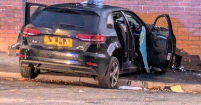 Police close road as three men hurt after car ploughs into wall