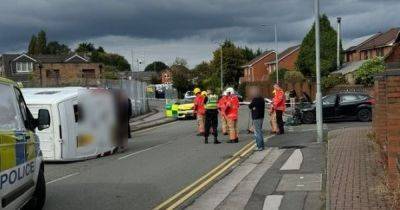 Van flips over in dramatic collision before emergency crews tape off street