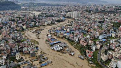 Flooding and landslides in Nepal kill at least 100 and dozens more missing