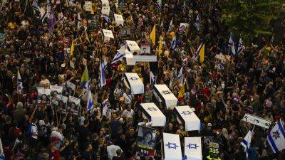 Protesters march in Tel Aviv with makeshift coffins to demand release of Gaza hostages