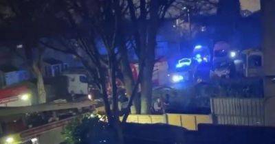House taped off and door smashed in as huge emergency response descends on residential street