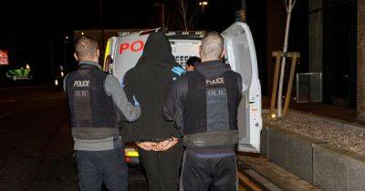 Suspects bundled into police vans after homes raided across south Manchester and gun found - manchestereveningnews.co.uk