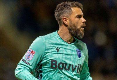 Gillingham goalkeeper Glenn Morris reacts to their defeat at Grimsby Town after having two players sent off and losing to a controversial penalty