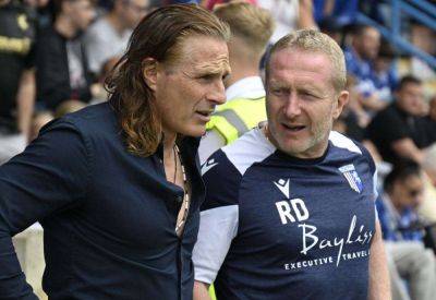 Gillingham assistant manager Richard Dobson is taking charge of the team at MK Dons while boss Gareth Ainsworth recovers from heart surgery