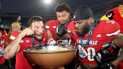 Louisville players dive into massive bowl of baked beans after bowl game victory - foxnews.com