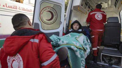 Trucks gather at the newly opened Rafah crossing to take aid into Gaza