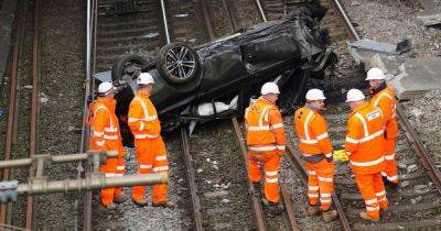 Police issue update after car crashes onto Manchester railway line