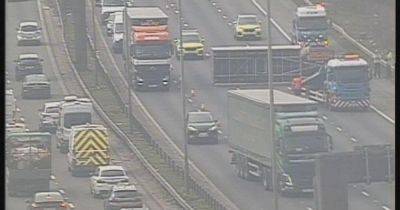 M60 traffic LIVE updates as lorry sheds load with three lanes shut
