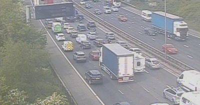 M60 LIVE as 'load spillage' causes heavy traffic - updates
