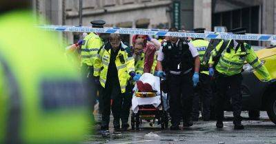 Man detained after car collides with pedestrians during Premier League parade
