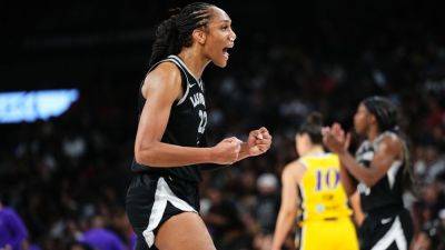 Aces star A'ja Wilson exits loss to Sparks with head injury - ESPN