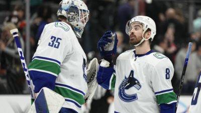 Vancouver Canucks sign goalie Thatcher Demko, winger Conor Garland to extensions