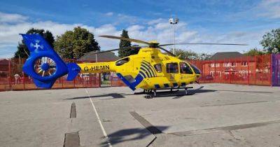 Air ambulance lands in Manchester park after police descend on flats