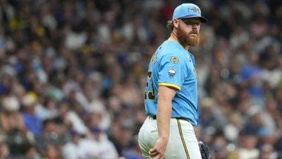 Brewers starter Brandon Woodruff heads to IL with lat strain - ESPN