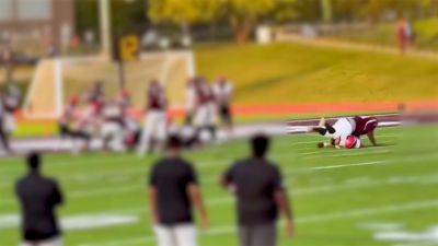 Michigan high school football player injured in vicious body slam returns to team in wheelchair