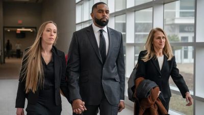 Ex-Michigan football coach Sherrone Moore walks into court hand in hand with wife ahead of latest hearing